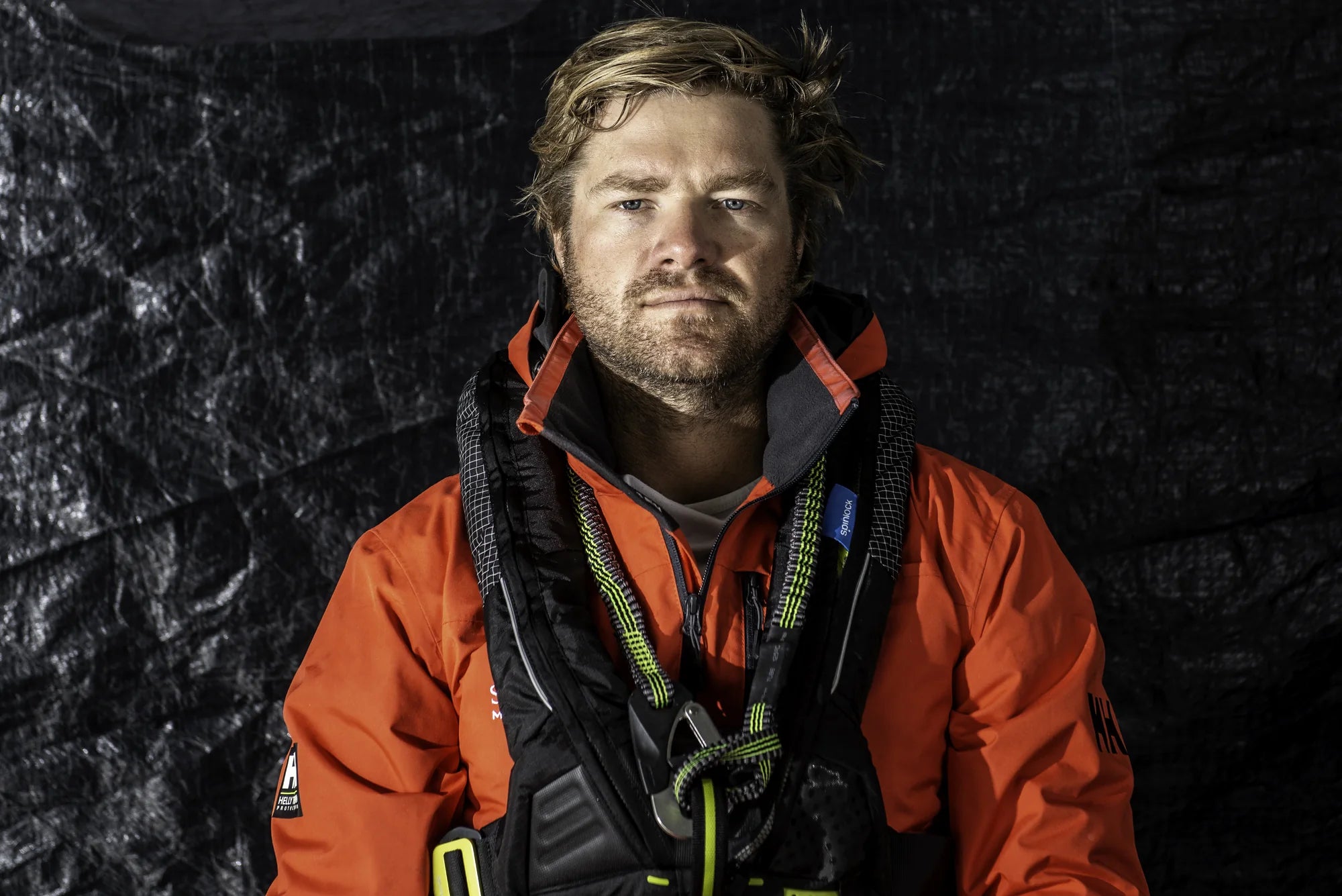 Jesse Fielding in orange sailing gear at the team base in Newport, photographed in September 2020.