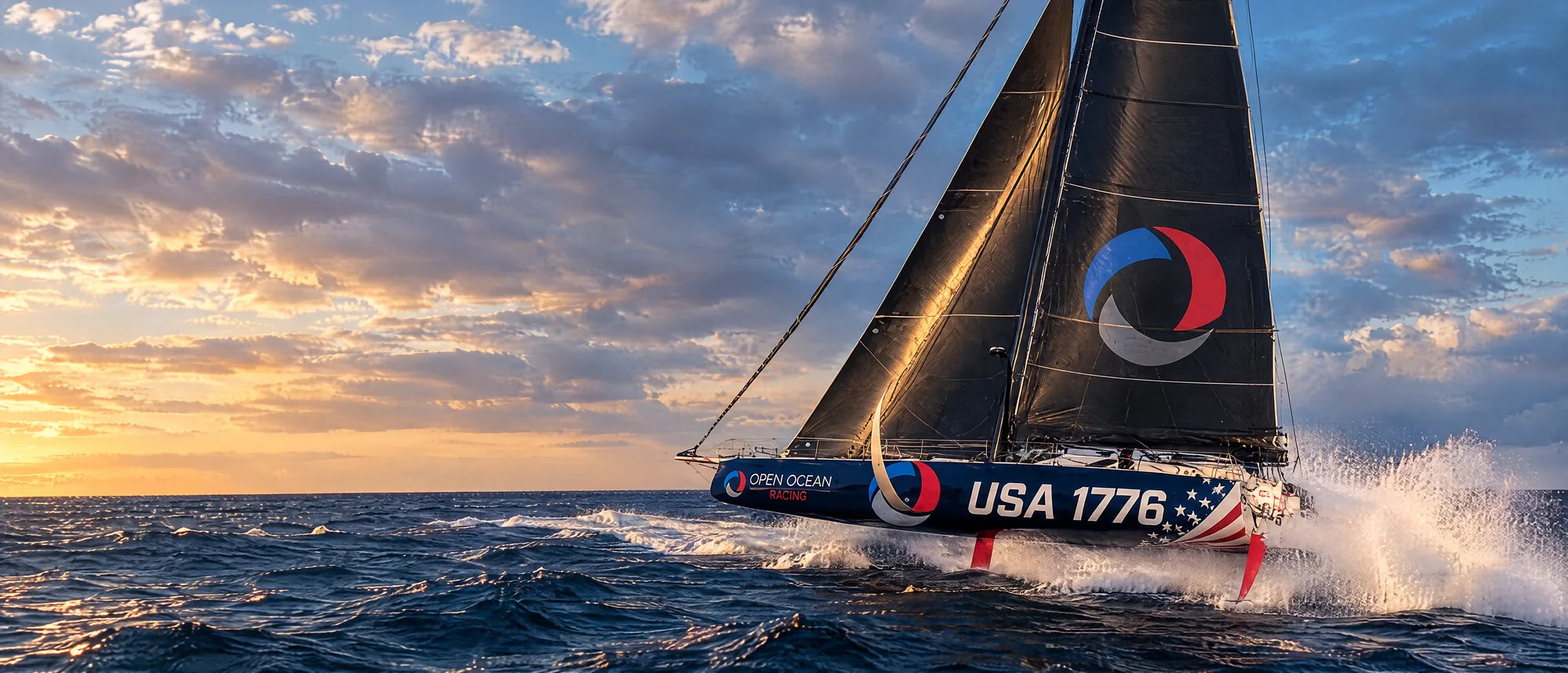 Visualisation of the Altum 68 in Open Ocean Racing livery, USA 1776 on the bow, sailing fast through spray at sunset.